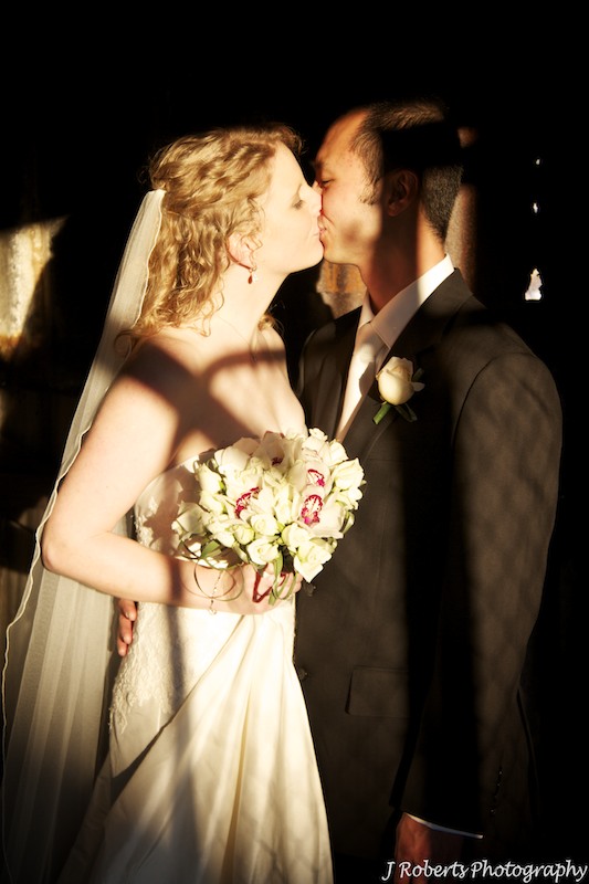Couple kissing with amazing sunset lighting - wedding photography sydney